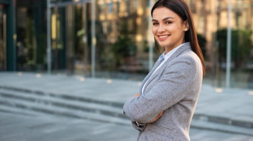 smiley-businesswoman-posing-outdoors-with-arms-crossed_23-2148767052